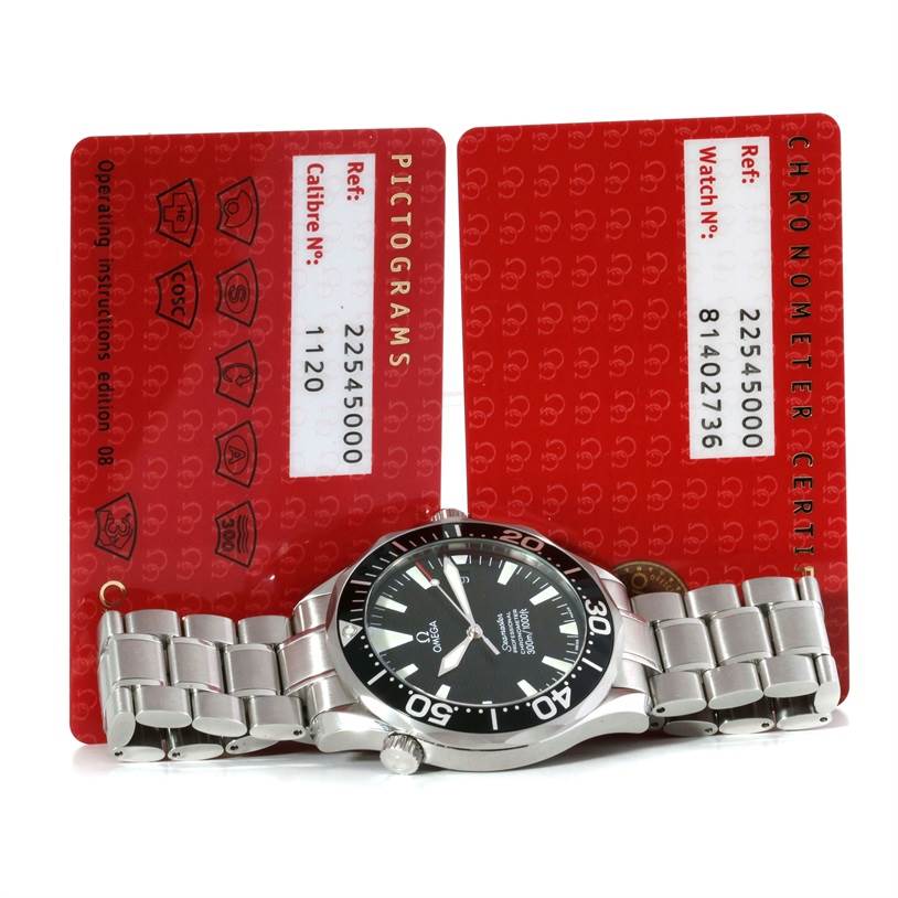 The Omega Seamaster 2254.50.00 Men's Stainless Steel Black Dial 2254.50.00 Men's Stainless Steel Black Dial watch is shown from a horizontal angle, with its bracelet extended and two red certificate cards behind it.