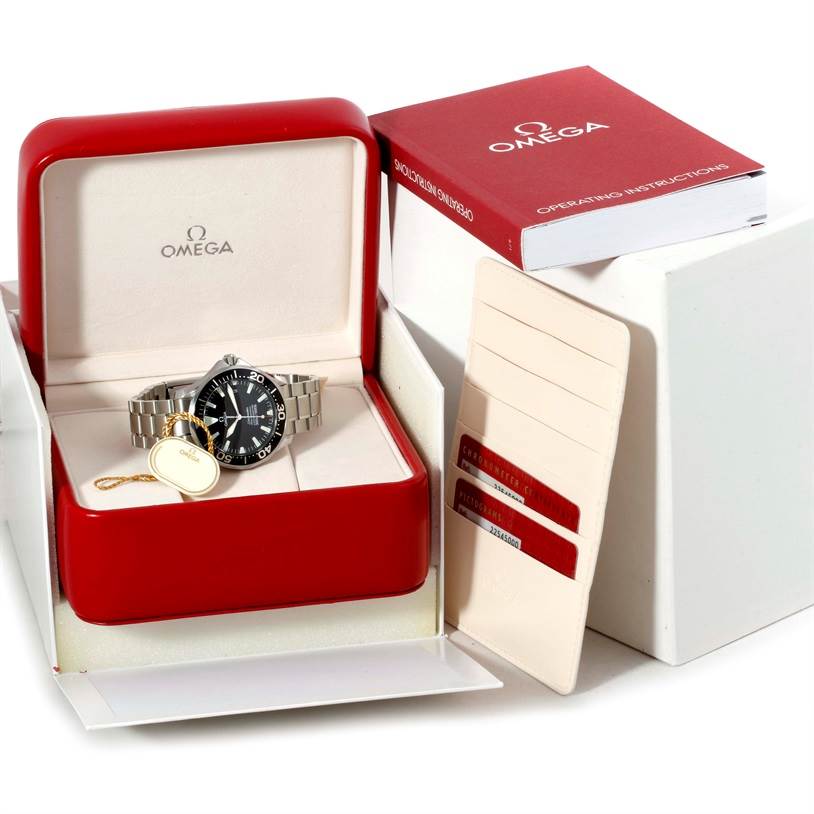 The Omega Seamaster 2254.50.00 Men's Stainless Steel Black Dial 2254.50.00 Men's Stainless Steel Black Dial watch is displayed front-facing in an open red box, alongside its operating instructions and cards.