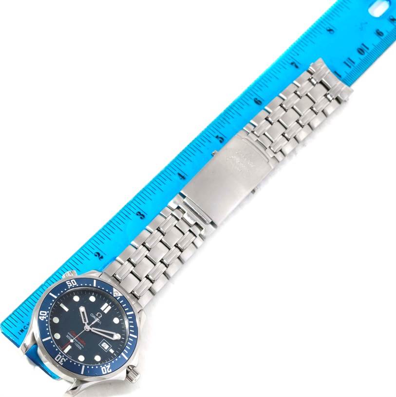 The image shows an Omega Seamaster 2221.80.00 Men
s Stainless Steel Blue Dial 2221.80.00 Men
s Stainless Steel Blue Dial watch laid flat, showcasing the face, bezel, and stainless steel bracelet next to a ruler.