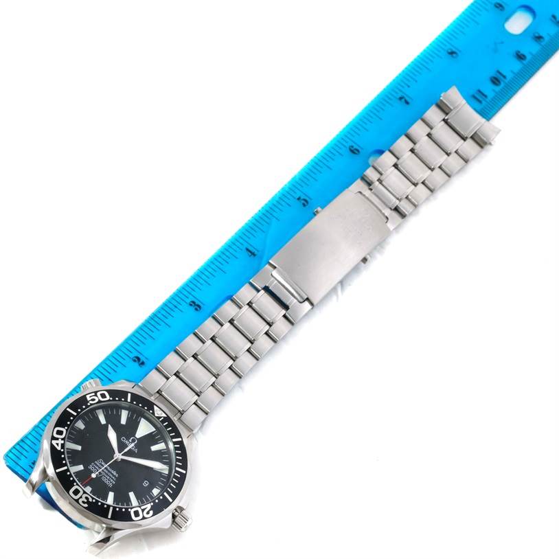 The Omega Seamaster 2254.50.00 Men
s Stainless Steel Black Dial 2254.50.00 Men
s Stainless Steel Black Dial watch is shown from a top-down angle with a blue ruler indicating the length of its metal bracelet.