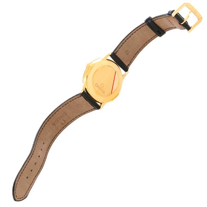 The image shows the back and strap of an Omega De Ville 4620.31 Men's Yellow Gold Silver Dial 4620.31 Men's Yellow Gold Silver Dial watch, featuring a gold case and black leather strap.