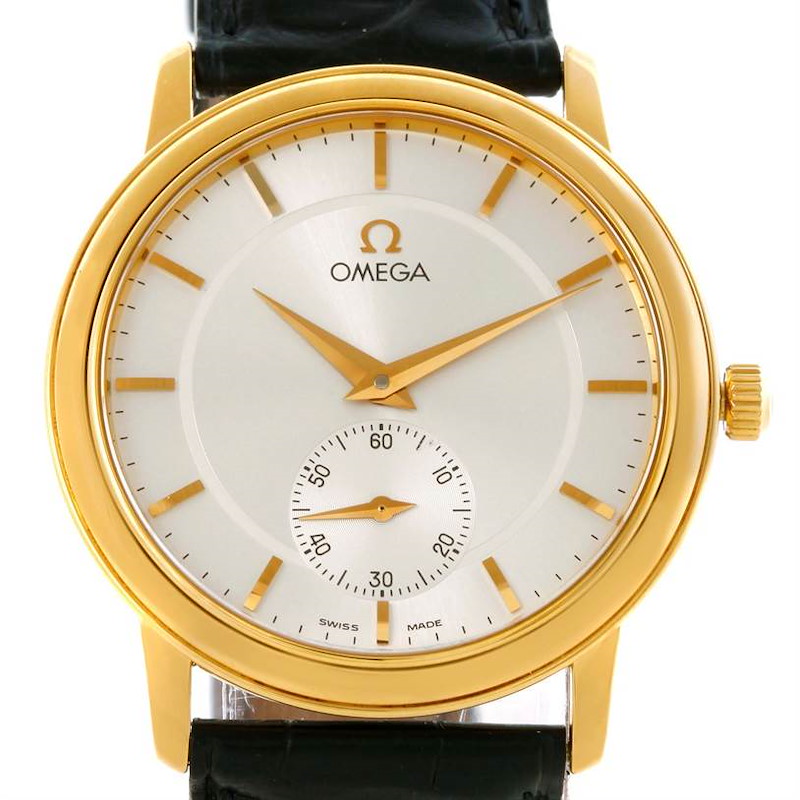 The image shows a front view of an Omega De Ville watch, highlighting its gold case, dial, hands, and subdial.