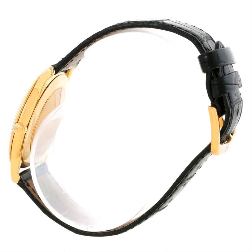 This side-angle view of the Omega De Ville 4620.31 Men's Yellow Gold Silver Dial 4620.31 Men's Yellow Gold Silver Dial watch highlights the black leather strap and gold-toned case.