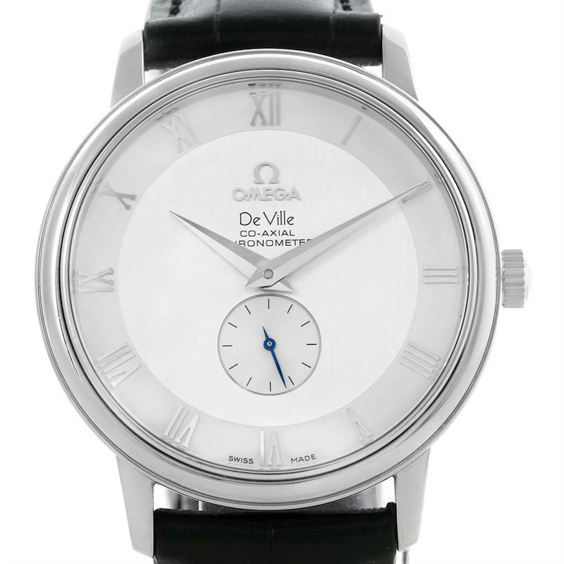 The image shows a front view of the Omega De Ville watch, highlighting the dial, hands, and part of the leather strap.