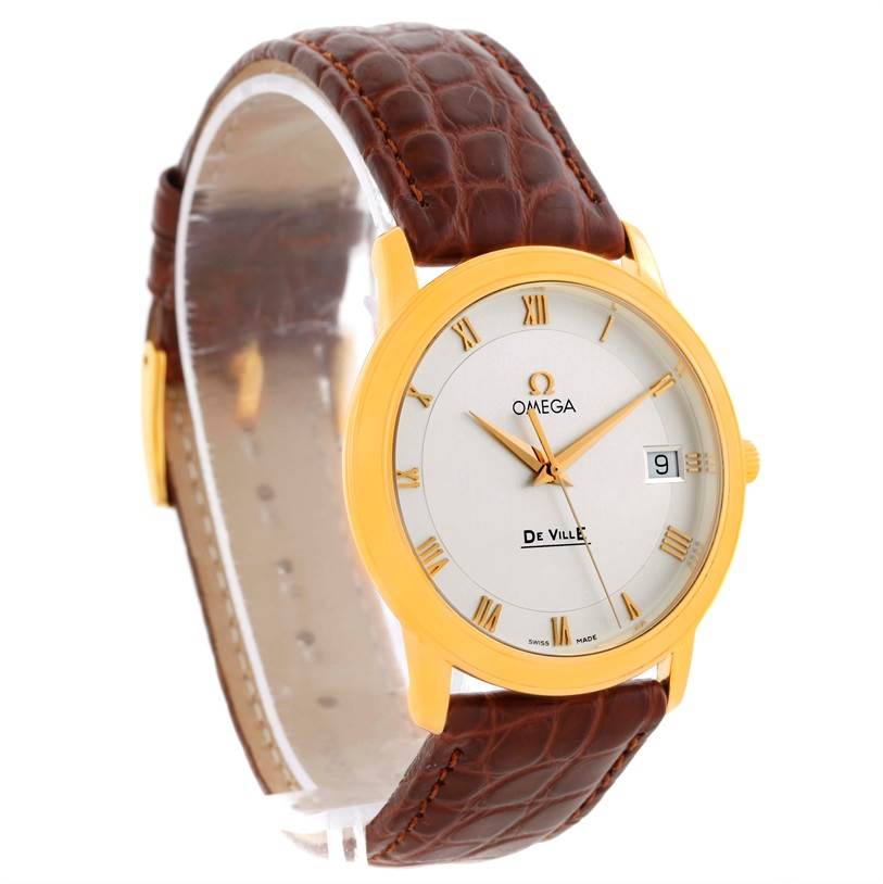 The image shows an angled view of an Omega De Ville Men's Yellow Gold Silver Dial Men's Yellow Gold Silver Dial watch, highlighting the face, gold case, and brown leather strap.