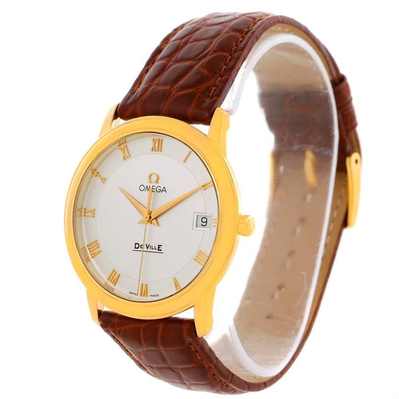 The Omega De Ville Men's Yellow Gold Silver Dial Men's Yellow Gold Silver Dial watch is shown at a slight angle, displaying the face, case, leather strap, and side crown.