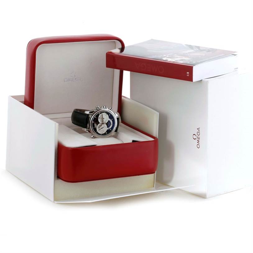 The image shows an Omega De Ville 4813.30.01 Men's Stainless Steel Black Dial 4813.30.01 Men's Stainless Steel Black Dial watch angled inside its open red box with an Omega booklet beside it.