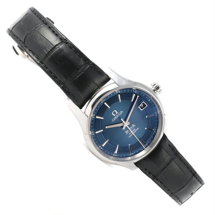 The image shows an Omega De Ville 431.33.41.21.03.001 Men's Stainless Steel Blue Dial 431.33.41.21.03.001 Men's Stainless Steel Blue Dial watch at an angle showcasing its blue dial, date window, and black leather strap.