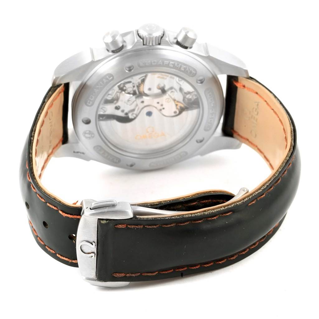 The image shows the back of an Omega De Ville 4851.61.31 Men
s Stainless Steel Red Dial 4851.61.31 Men
s Stainless Steel Red Dial watch, highlighting the movement through a transparent case back and a partially open leather strap.