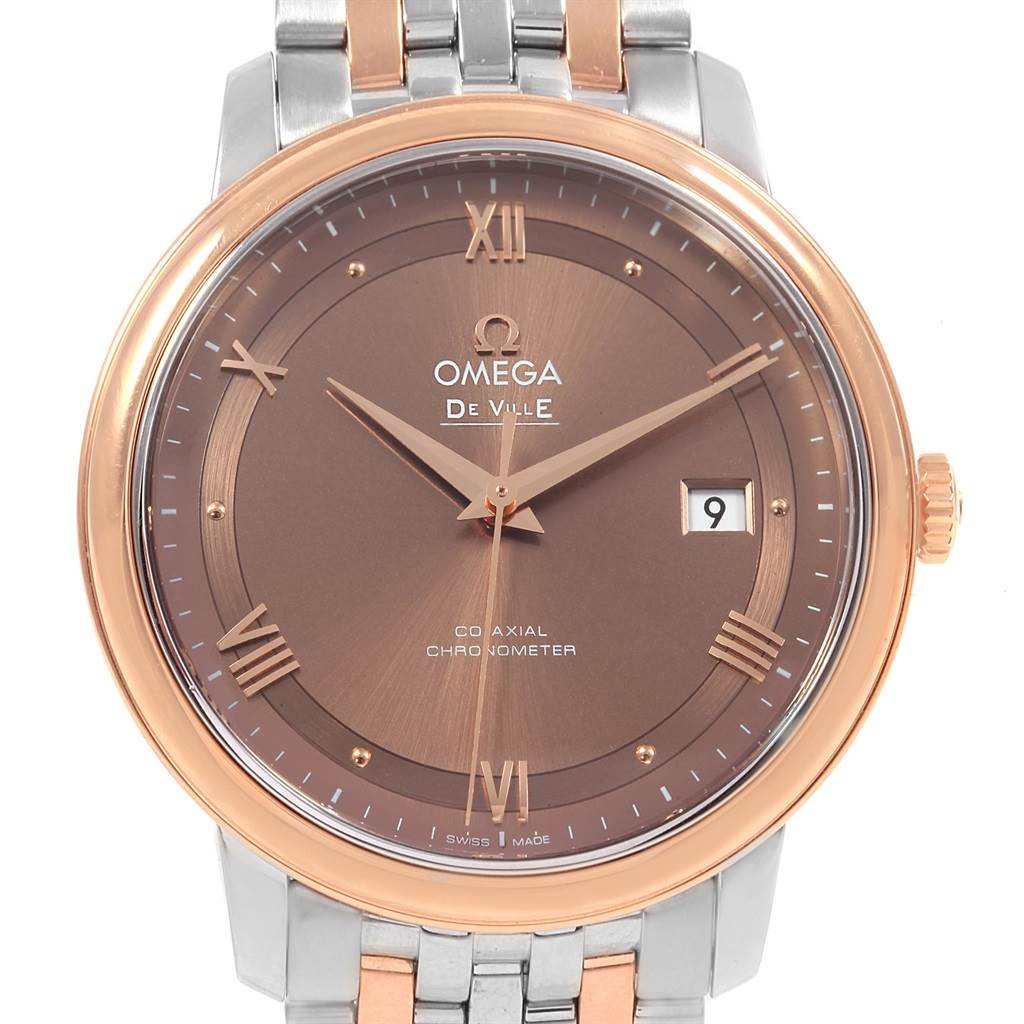 The image displays a front view of an Omega De Ville 424.20.40.20.13.001 Men's Steel and Gold (two tone) Brown Dial 424.20.40.20.13.001 Men's Steel and Gold (two tone) Brown Dial watch, showcasing its face, bezel, hands, and part of the bracelet.