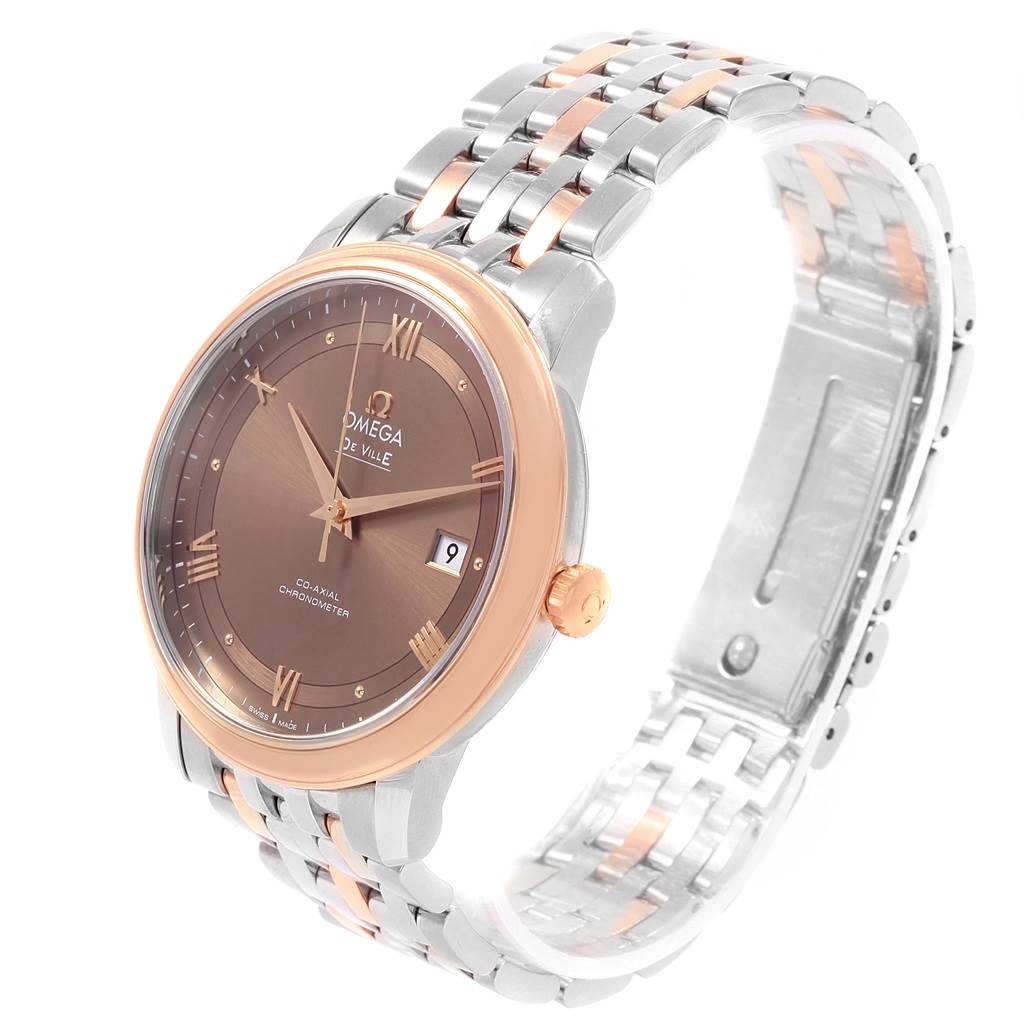 The image shows an angled view of an Omega De Ville 424.20.40.20.13.001 Men's Steel and Gold (two tone) Brown Dial 424.20.40.20.13.001 Men's Steel and Gold (two tone) Brown Dial watch, featuring its face, bezel, crown, and bracelet.