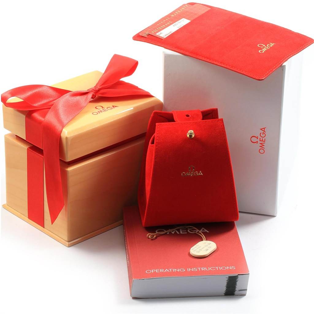 The image shows Omega De Ville 4851.61.31 Men's Stainless Steel Red Dial 4851.61.31 Men's Stainless Steel Red Dial watch accessories, including boxes, a red pouch, a manual, and tags.