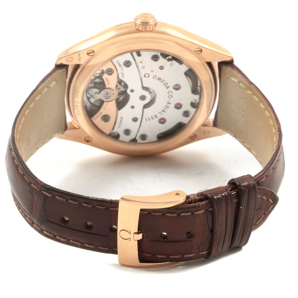 The image shows the back view of an Omega De Ville 432.53.40.21.02.002 Men's Rose Gold Silver Dial 432.53.40.21.02.002 Men's Rose Gold Silver Dial watch, displaying its movement and brown leather strap with the buckle.