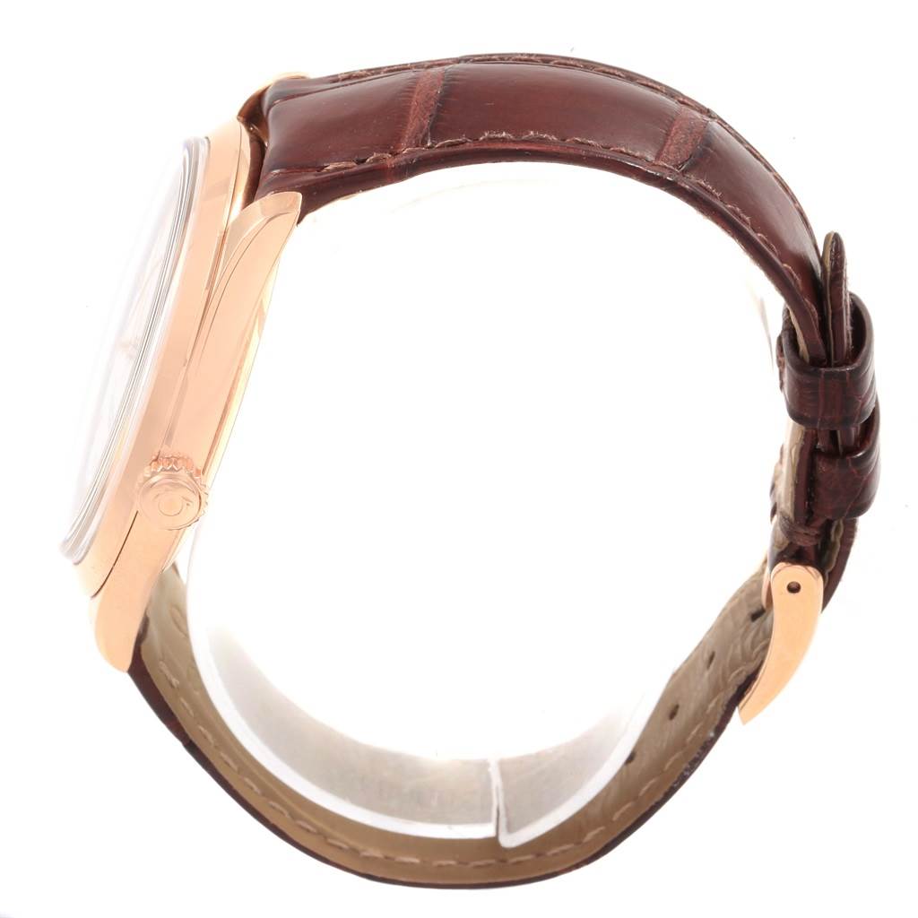 The image shows a side view of the Omega De Ville 432.53.40.21.02.002 Men's Rose Gold Silver Dial 432.53.40.21.02.002 Men's Rose Gold Silver Dial watch, featuring its rose gold case and brown leather strap.