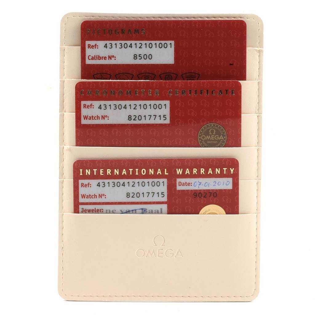 This image shows the warranty and certification cards for an Omega De Ville 431.30.41.21.01.001 Men
s Stainless Steel Black Dial 431.30.41.21.01.001 Men
s Stainless Steel Black Dial watch, displayed in a beige holder.