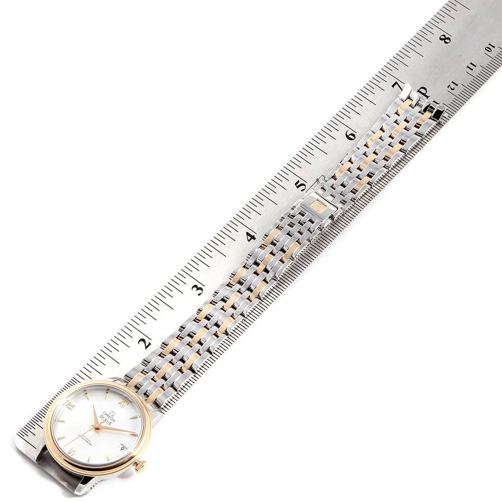 The image shows the Omega De Ville 424.20.33.20.05.001 Men's Steel and Gold (two tone) Mother of Pearl Dial 424.20.33.20.05.001 Men's Steel and Gold (two tone) Mother of Pearl Dial watch laid flat next to a ruler, displaying its face and band length.