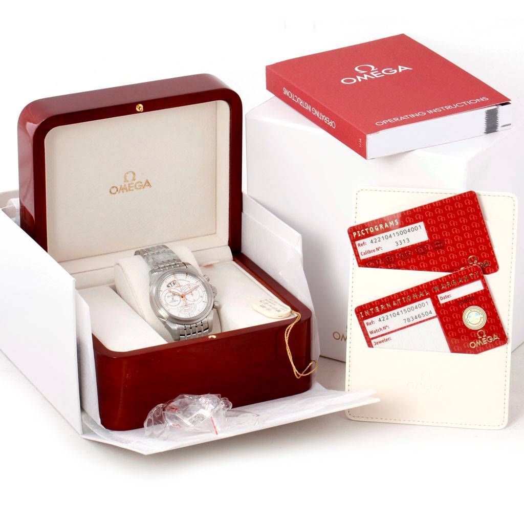 The Omega De Ville 422.10.41.50.04.001 Men's Stainless Steel White Dial 422.10.41.50.04.001 Men's Stainless Steel White Dial watch is shown at an angle in its box, with an instruction manual and warranty cards displayed.