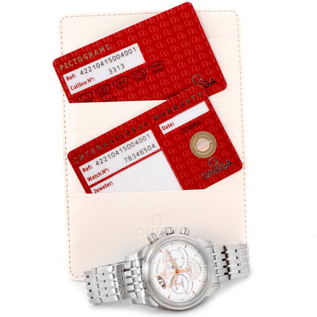 The Omega De Ville 422.10.41.50.04.001 Men's Stainless Steel White Dial 422.10.41.50.04.001 Men's Stainless Steel White Dial watch is shown from a top-down angle along with its warranty and pictograms cards.