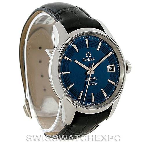 The image shows a side angle view of an Omega De Ville 431.33.41.21.03.001 Men's Stainless Steel Blue Dial 431.33.41.21.03.001 Men's Stainless Steel Blue Dial watch, highlighting its blue dial, metal case, date window, and black leather strap.
