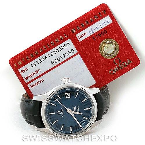 The image shows an Omega De Ville 431.33.41.21.03.001 Men's Stainless Steel Blue Dial 431.33.41.21.03.001 Men's Stainless Steel Blue Dial watch with a black leather strap, positioned in front of its red international warranty card.
