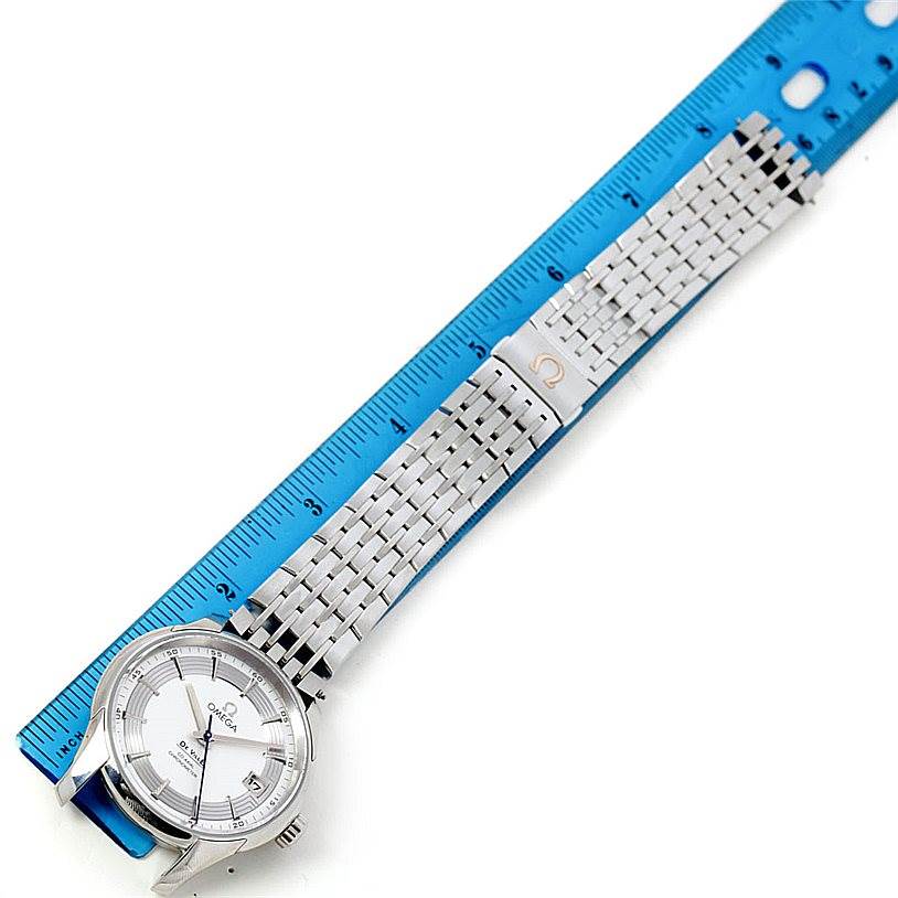 The Omega De Ville 431.30.41.22.02.001 Men's Stainless Steel Silver Dial 431.30.41.22.02.001 Men's Stainless Steel Silver Dial watch is shown from a top-down angle, highlighting its face, bezel, and metal bracelet alongside a ruler.