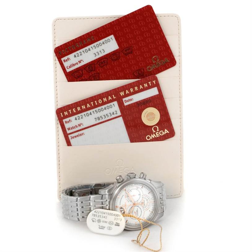 The image shows an Omega De Ville 422.10.41.50.04.001 Men's Stainless Steel White Dial 422.10.41.50.04.001 Men's Stainless Steel White Dial watch lying flat with its warranty card and tag, also displaying its holder.