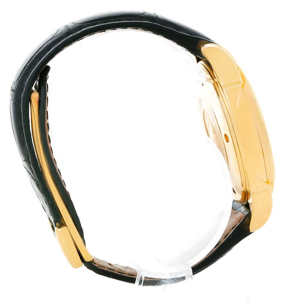 Side view of an Omega De Ville 4633.30.31 Men's Yellow Gold Silver Dial 4633.30.31 Men's Yellow Gold Silver Dial watch showing the case, strap, and crown.