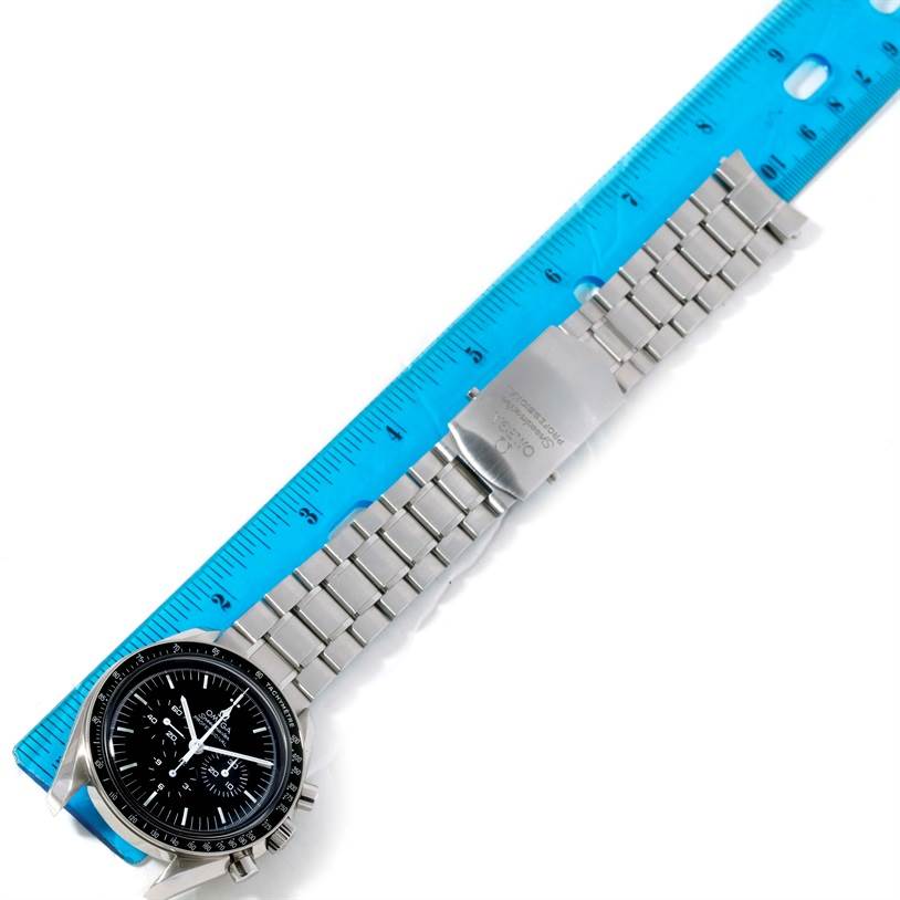 This image shows the Omega Speedmaster 311.30.42.30.01.005 Men
s Stainless Steel Black Dial 311.30.42.30.01.005 Men
s Stainless Steel Black Dial watch from a top-down angle, displaying the watch face and stainless steel bracelet alongside a ruler for scale.