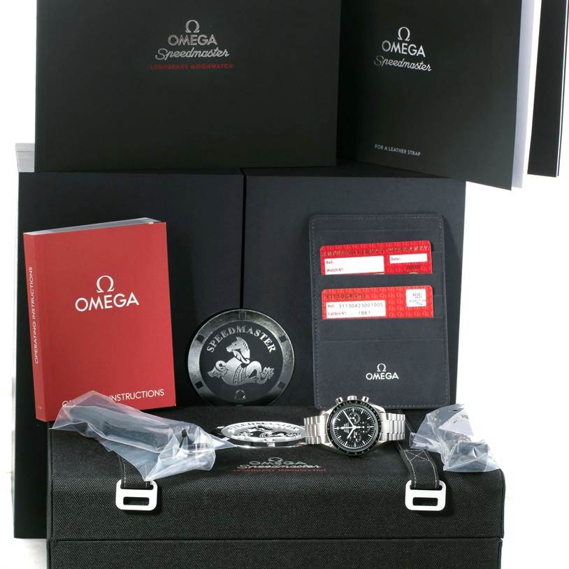 The image shows an Omega Speedmaster 311.30.42.30.01.005 Men
s Stainless Steel Black Dial 311.30.42.30.01.005 Men
s Stainless Steel Black Dial watch and its accessories, including manuals, warranty cards, and packaging, from a front angle.