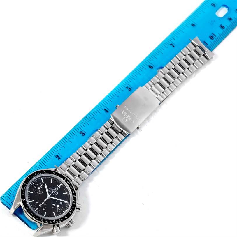 This image shows the Omega Speedmaster 3539.50.00 Men
s Stainless Steel Black Dial 3539.50.00 Men
s Stainless Steel Black Dial watch laid flat with its bracelet fully extended alongside a ruler for measurement.