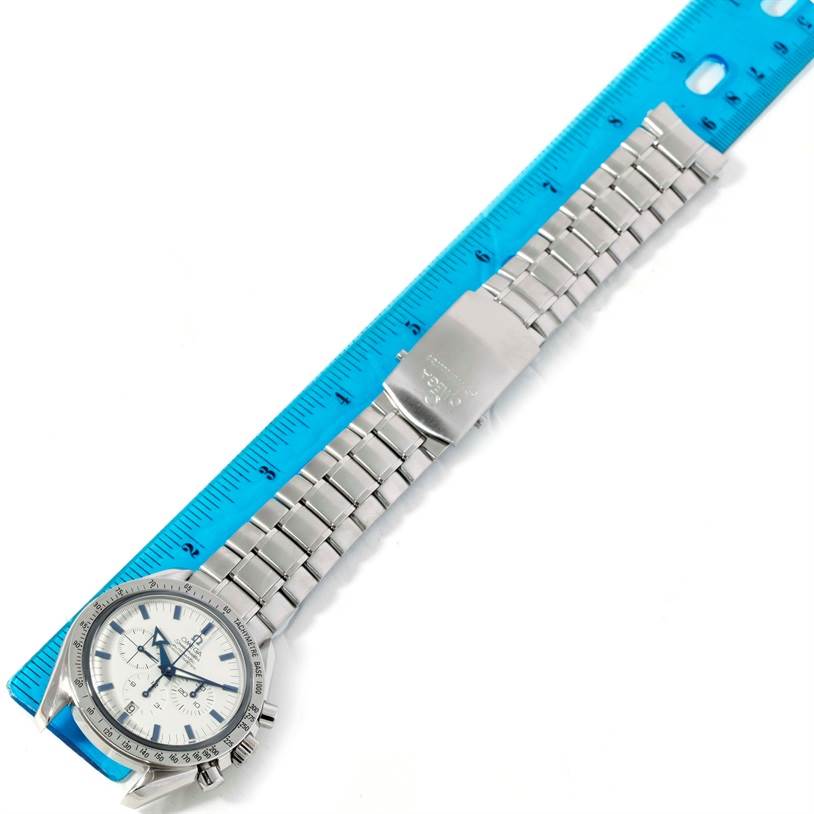The image shows an Omega Speedmaster 3551.20.00 Men
s Stainless Steel White Dial 3551.20.00 Men
s Stainless Steel White Dial watch positioned next to a ruler, displaying its face and stainless steel bracelet.