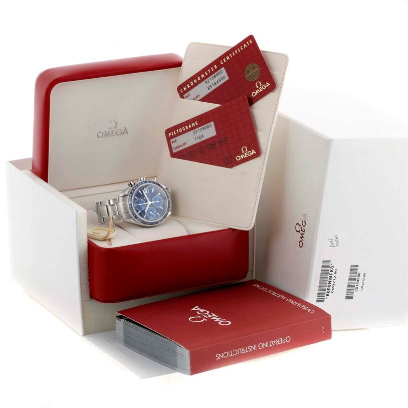 The Omega Speedmaster 3212.80.00 Men
s Stainless Steel Blue Dial 3212.80.00 Men
s Stainless Steel Blue Dial watch is shown inside its open box with certificates and operating instructions.