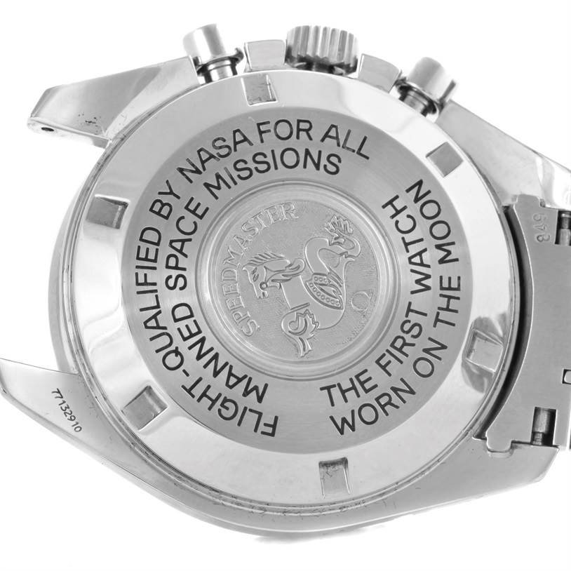 The image shows the back case of the Omega Speedmaster 3575.20.00 Men
s Stainless Steel White Dial 3575.20.00 Men
s Stainless Steel White Dial watch, including the engraving and some parts of the bracelet and pushers.