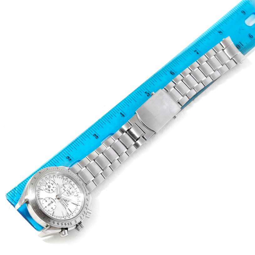 The image shows an Omega Speedmaster 3523.30.00 Men
s Stainless Steel Silver Dial 3523.30.00 Men
s Stainless Steel Silver Dial watch, laid flat with the bracelet extended alongside a blue ruler for measurement.