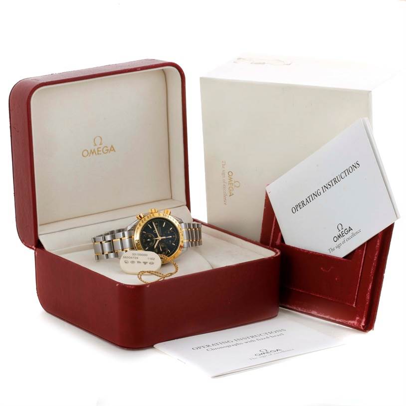 The Omega Speedmaster 3313.50.00 Men's Steel and Gold (two tone) Black Dial 3313.50.00 Men's Steel and Gold (two tone) Black Dial watch and its accessories, including the box and operating instructions, are shown from a three-quarter angle.