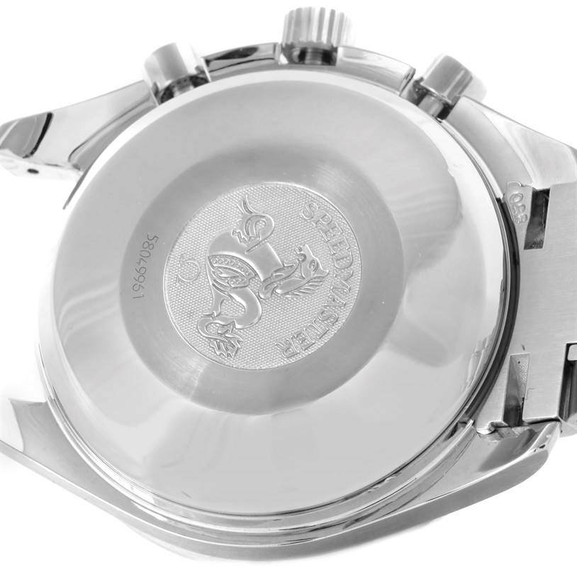 The image shows the back casing of an Omega Speedmaster Men
s Stainless Steel Blue Dial Men
s Stainless Steel Blue Dial watch engraved with the emblem and surrounding details.