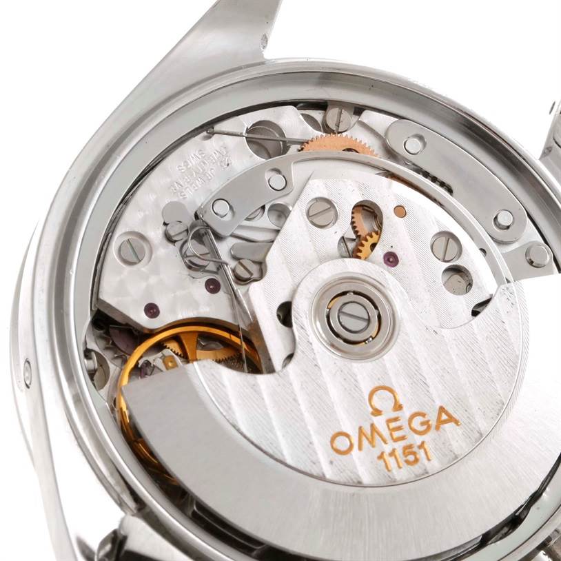 The image shows an Omega Speedmaster 3523.80.00 Men
s Stainless Steel Blue Dial 3523.80.00 Men
s Stainless Steel Blue Dial watch
s inner mechanical movement, revealing gears, rotors, and the "Omega 1151" engraving.