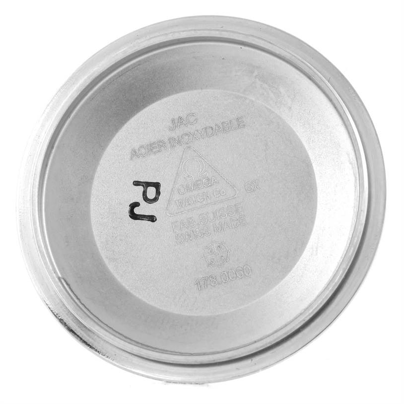 This image shows the inside of the case back from an Omega Speedmaster 3220.50.00 Men
s Stainless Steel Black Dial 3220.50.00 Men
s Stainless Steel Black Dial watch, detailing its inscriptions.