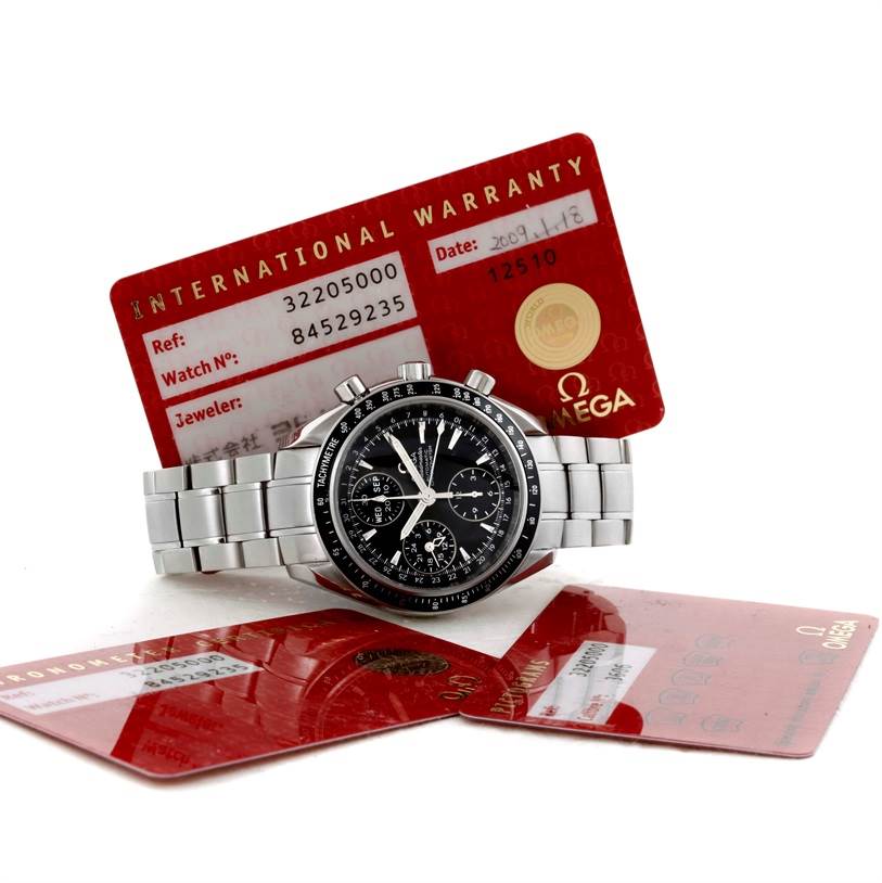 The Omega Speedmaster 3220.50.00 Men
s Stainless Steel Black Dial 3220.50.00 Men
s Stainless Steel Black Dial watch is shown at a front angle with warranty cards in the background.