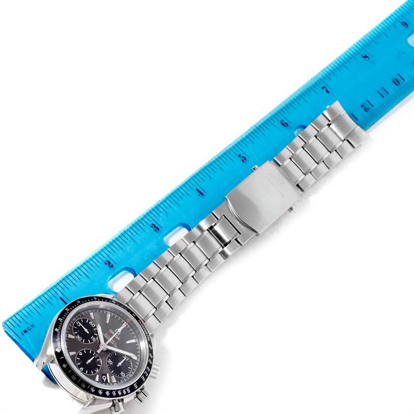 The image shows the Omega Speedmaster 323.30.40.40.06.001 Men
s Stainless Steel Grey Dial 323.30.40.40.06.001 Men
s Stainless Steel Grey Dial watch laid next to a blue ruler, displaying the face and stainless steel bracelet.