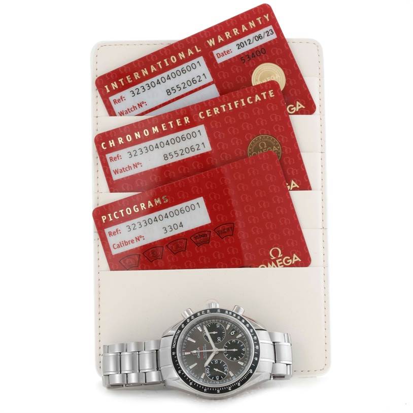 The image shows an Omega Speedmaster 323.30.40.40.06.001 Men
s Stainless Steel Grey Dial 323.30.40.40.06.001 Men
s Stainless Steel Grey Dial watch and its international warranty, chronometer certificate, and pictograms cards.