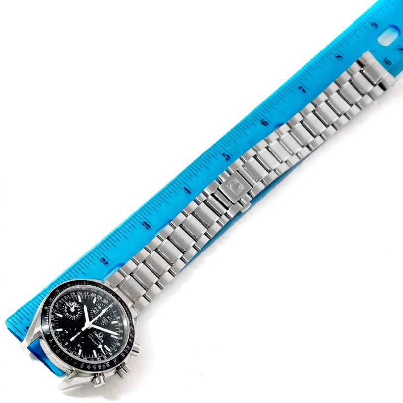 The Omega Speedmaster 3520.50.00 Men
s Stainless Steel Black Dial 3520.50.00 Men
s Stainless Steel Black Dial watch is shown from the top, displaying its face and metal bracelet beside a ruler for measurement.