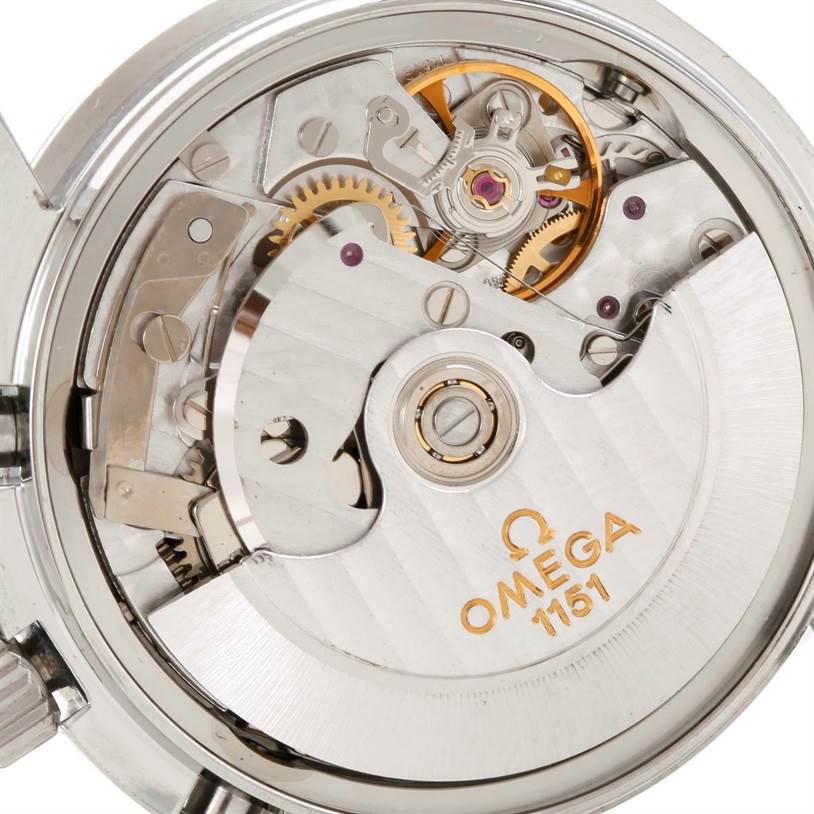 The image shows the inner mechanics and movement of an Omega Speedmaster 3520.50.00 Men
s Stainless Steel Black Dial 3520.50.00 Men
s Stainless Steel Black Dial watch, focusing on gears and the oscillating weight.