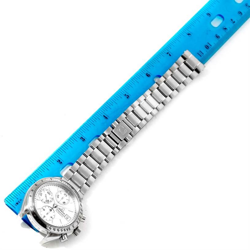 The Omega Speedmaster 3513.30.00 Men
s Stainless Steel Silver Dial 3513.30.00 Men
s Stainless Steel Silver Dial watch is shown at a top-down angle, focusing on the watch face and metal bracelet beside a ruler.