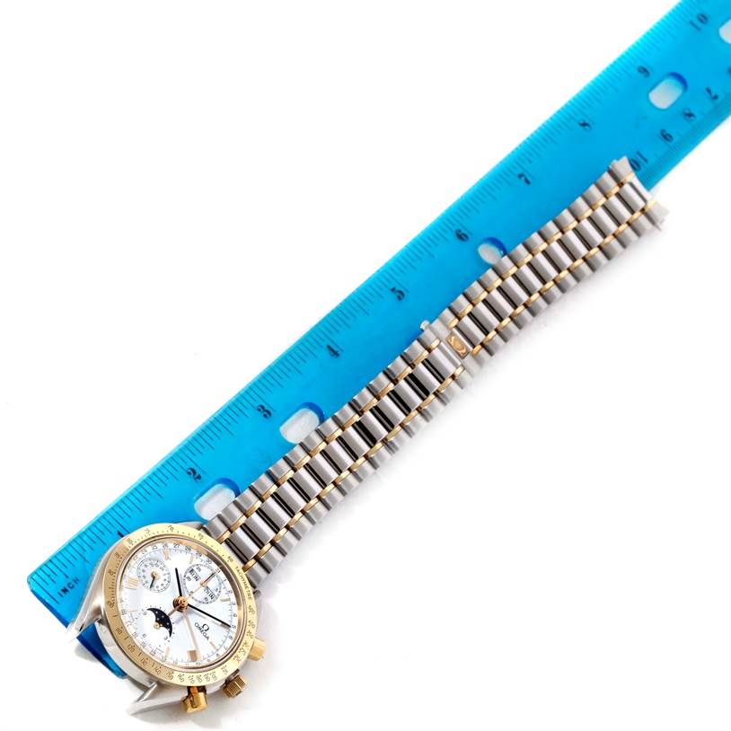 The image shows an Omega Speedmaster 3330.20.00 Men
s Stainless Steel White Dial 3330.20.00 Men
s Stainless Steel White Dial watch laid flat alongside a blue ruler, showcasing its face and bracelet.