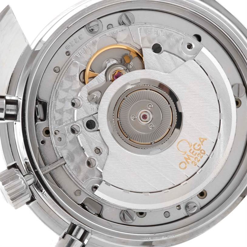 The image shows the inner movement mechanism of the Omega Speedmaster 3510.50.00 Men
s Stainless Steel Black Dial 3510.50.00 Men
s Stainless Steel Black Dial watch, highlighting gears, cogs, and the rotor.