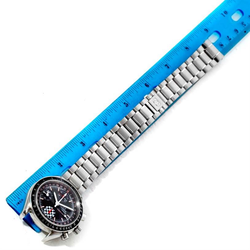 The image shows an Omega Speedmaster 3529.50.00 Men
s Stainless Steel Black Dial 3529.50.00 Men
s Stainless Steel Black Dial watch laid flat with a metal bracelet, next to a blue ruler for scale.