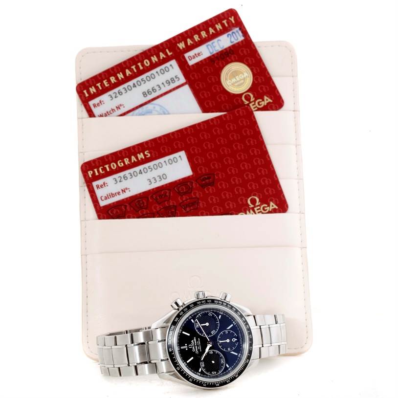 The Omega Speedmaster 326.30.40.50.01.001 Men
s Stainless Steel Black Dial 326.30.40.50.01.001 Men
s Stainless Steel Black Dial watch is shown from the front, with warranty cards and a pictogram card in the background.