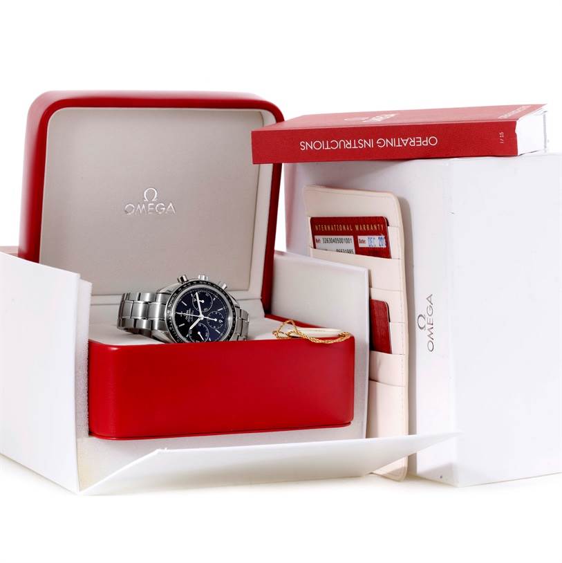 The image shows an Omega Speedmaster 326.30.40.50.01.001 Men
s Stainless Steel Black Dial 326.30.40.50.01.001 Men
s Stainless Steel Black Dial watch in its open case, alongside warranty cards and an instruction manual.