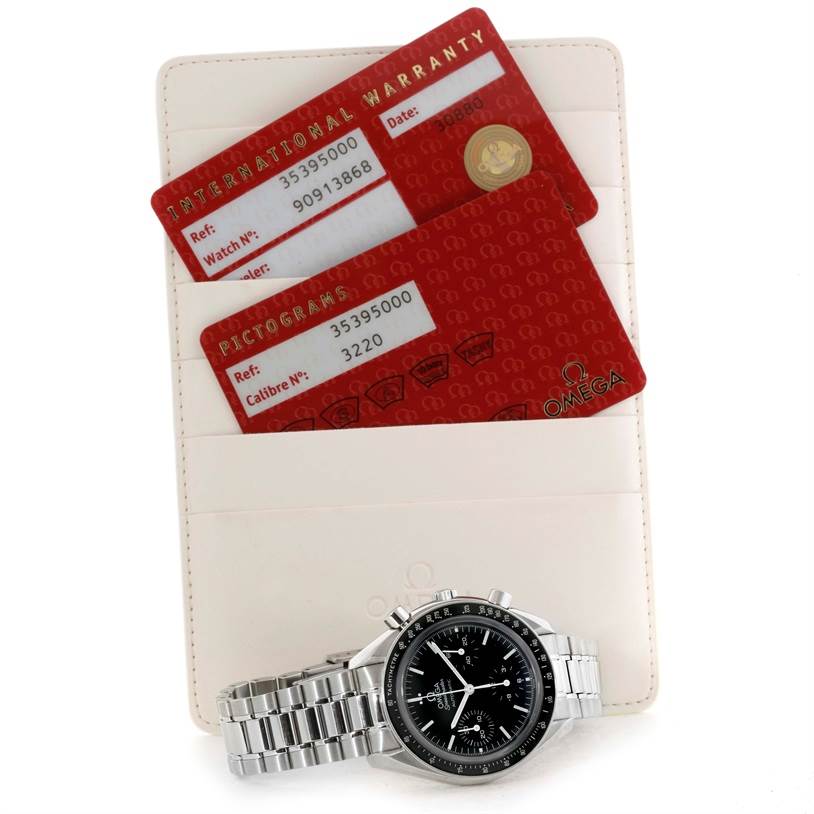 The image shows an Omega Speedmaster 3539.50.00 Men
s Stainless Steel Black Dial 3539.50.00 Men
s Stainless Steel Black Dial watch with two identification cards and a white holder, viewed from a top angle.